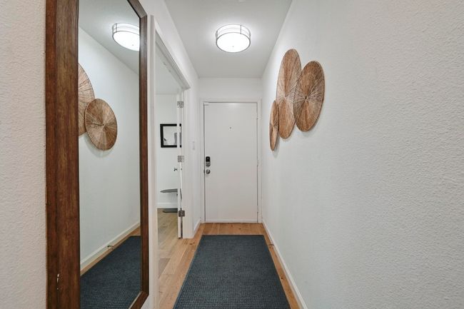 The front door opens into the entryway, which flows past one of the secondary bedrooms. | Image 29