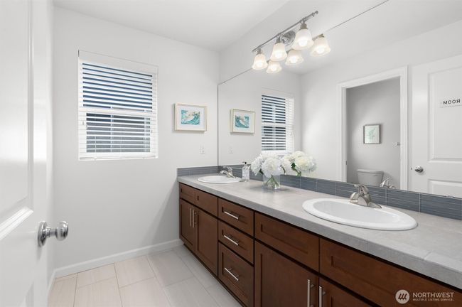 The upstairs full bathroom features a double sink vanity + a separate tub/shower and toilet room! | Image 30