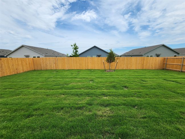 View of fenced backyard | Image 13