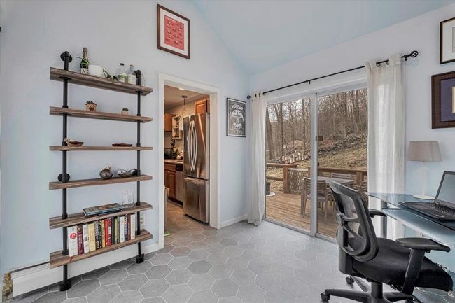 Den/Office area with baseboards and vaulted ceiling | Image 9
