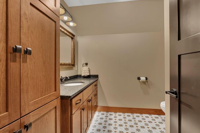 Stylish 3/4 bath featuring custom tile work and modern fixtures, combining function with elegant design. | Image 71