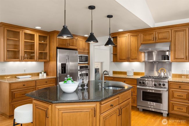 Unleash your inner chef in a fully renovated kitchen featuring a premium Wolf range, sleek surfaces, and custom cabinetry. | Image 6