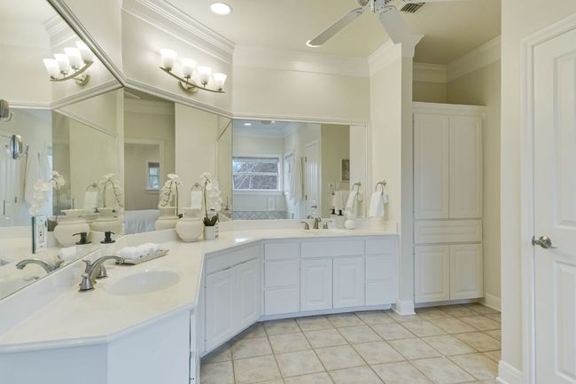 Bathroom with double vanity, crown molding, soaking tub, separate shower and two expansive walk-in closets. | Image 20