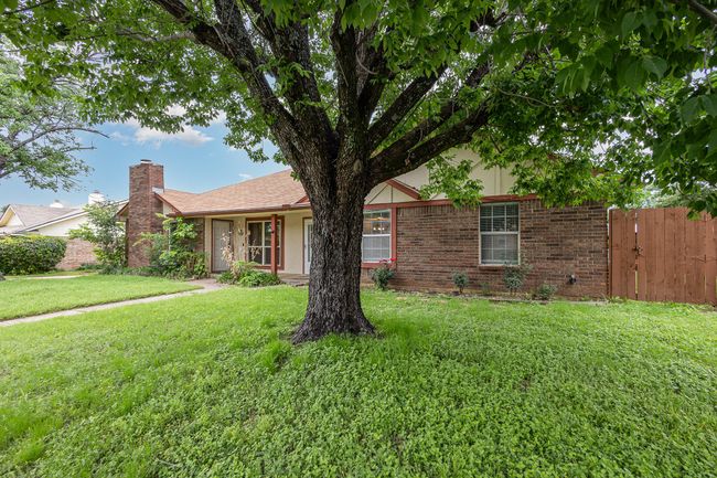 Single story home featuring brick siding and a chimney | Image 6