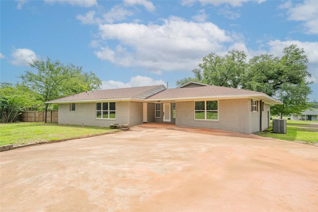 Single story home featuring driveway, brick siding, and a shingled roof | Image 29