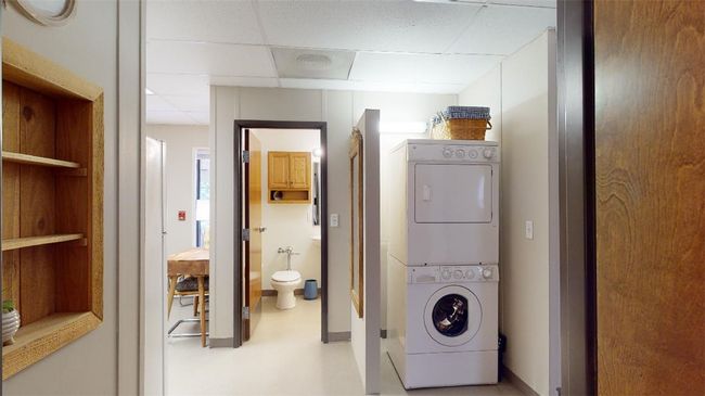 Laundry room with stacked washer and clothes dryer | Image 35