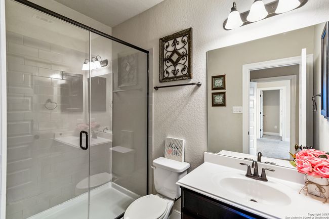A modern bathroom featuring a sink, a shower, a to | Image 15