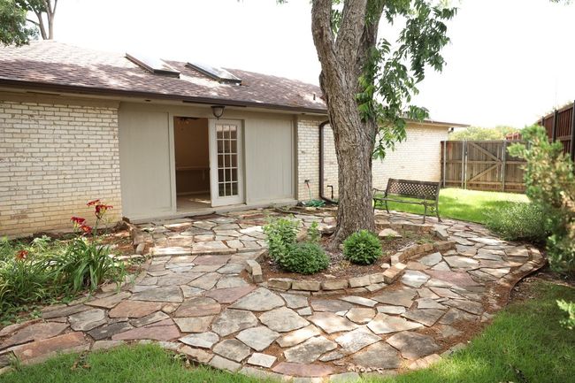 Back of house with brick siding, a patio area, and roof with shingles | Image 32