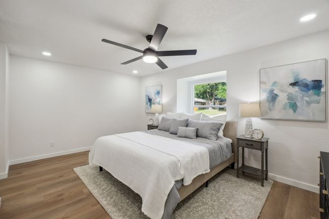 Bedroom with wood finished floors, baseboards, ceiling fan, and recessed lighting | Image 19