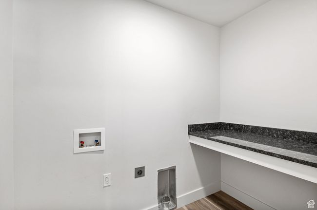 Laundry Room featuring electric dryer hookup, washer hookup, with Granite topped folding table | Image 21
