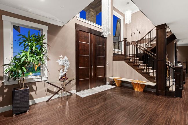 Foyer entrance with stairs, wood finished floors, ornamental molding, and baseboards | Image 4