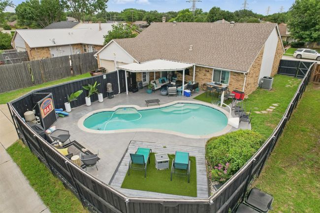 View of swimming pool featuring an outdoor living space, a fenced backyard, and a patio | Image 34