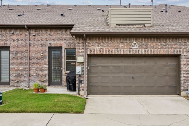 View of exterior entry featuring driveway and roof with shingles | Image 24
