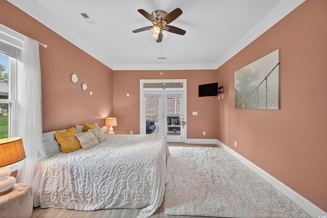 Bedroom featuring access to outside, crown molding, and a ceiling fan | Image 39