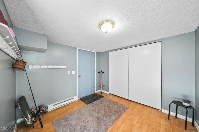 Room featuring hardwood / wood-style flooring and a textured ceiling | Image 23
