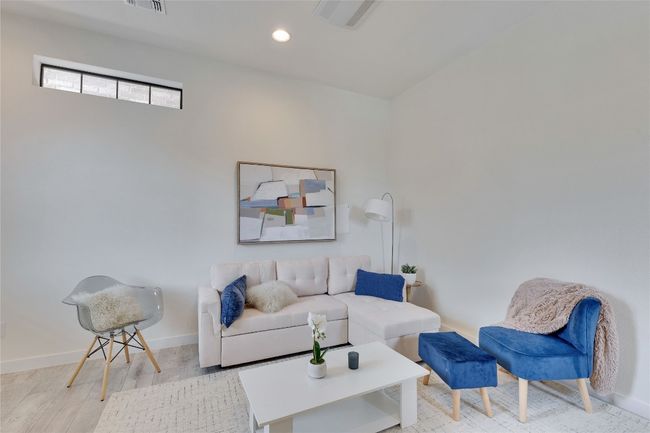 Living area with wood finished floors and recessed lighting | Image 6