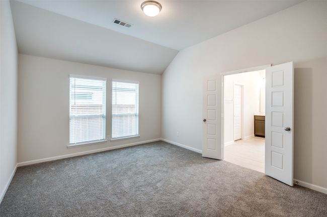 Empty room featuring light carpet and lofted ceiling | Image 15
