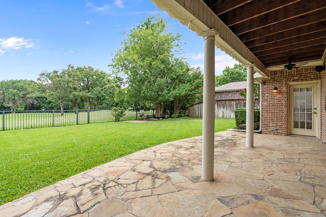 Covered patio with serene golf course views | Image 27