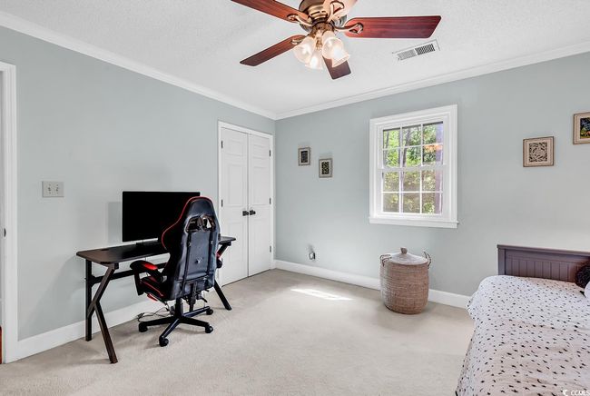 Carpeted office with crown molding and ceiling fan | Image 26