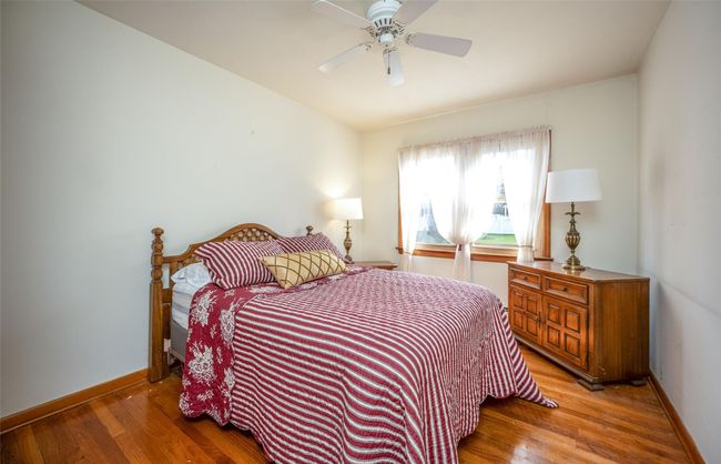 Bedroom 2 with ceiling fan, wood floors, closet | Image 8