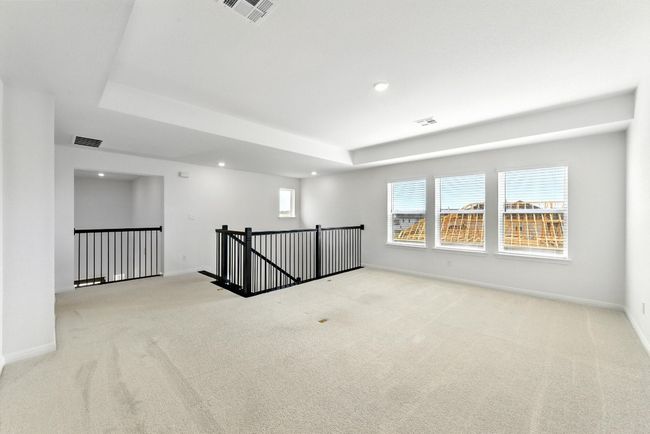 Unfurnished room featuring carpet, recessed lighting, baseboards, and a raised ceiling | Image 22
