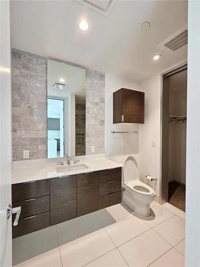 Bathroom featuring visible vents, tile patterned floors, toilet, and vanity | Image 8