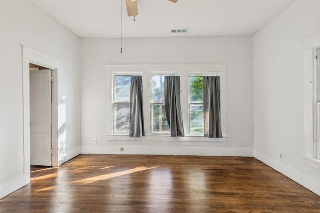 Empty room featuring wood-type flooring, ceiling fan, and baseboards | Image 8