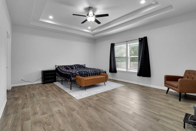 Primary bedroom with large window, recessed ceiling and fan | Image 11