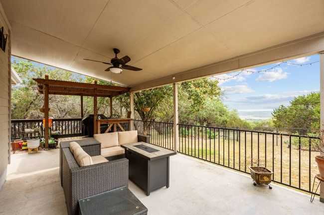 View of patio featuring a ceiling fan and an outdoor living space with a fire pit | Image 24