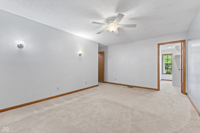 empty room with ceiling fan, light colored carpet, baseboards, and a textured ceiling | Image 28