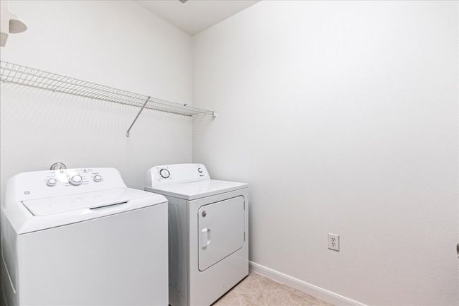 The laundry room is well-sized. | Image 26