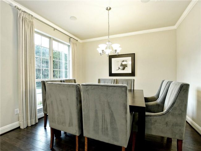 Dining area featuring a chandelier, dark wood finished floors, and ornamental molding | Image 13