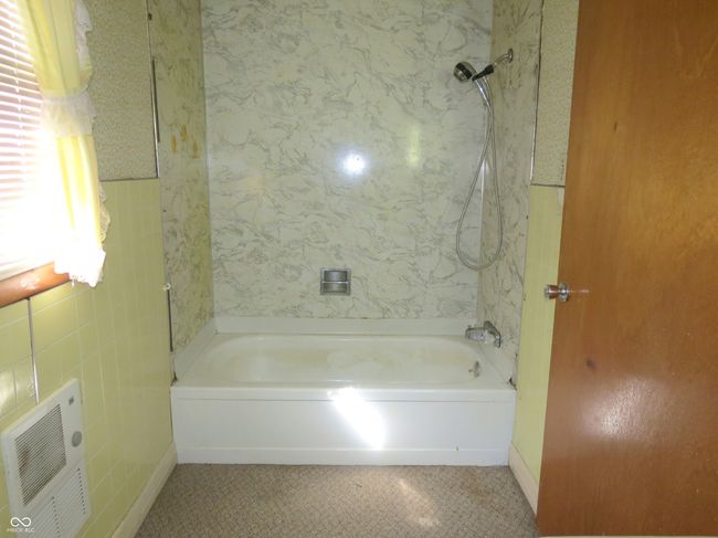 bathroom featuring tile patterned floors, visible vents, and shower combination | Image 11
