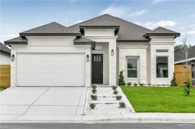 Prairie-style home with a garage and a front lawn | Image 1