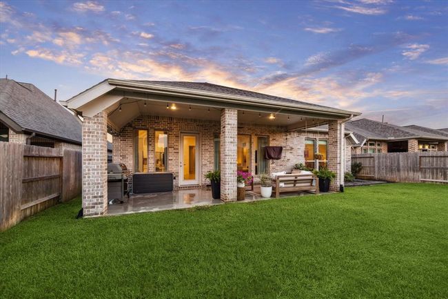 Elegant brick columns frame the covered patio, creating a stylish, shaded space, an ideal spot to gather, relax, and stay cool right at home. | Image 29