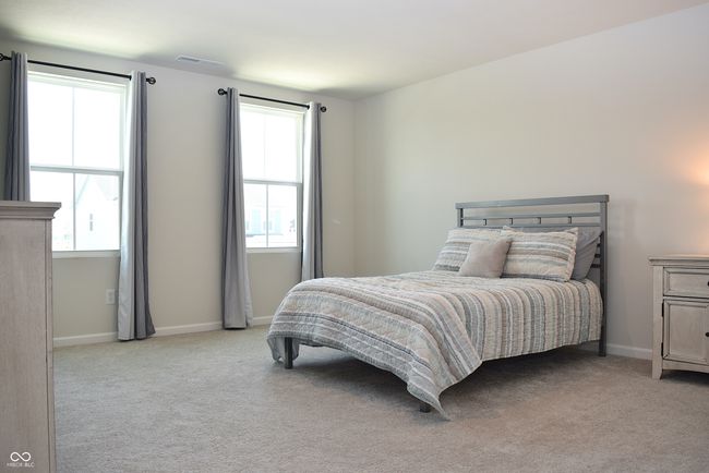primary bedroom with two windows located at front of home | Image 26