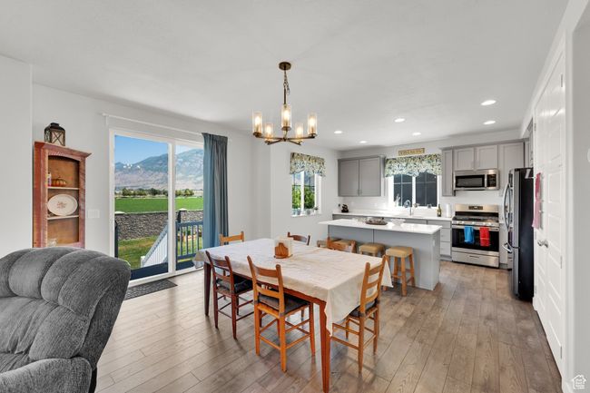 Dining space with a chandelier, recessed lighting, light wood finished floors, and a mountain view | Image 5