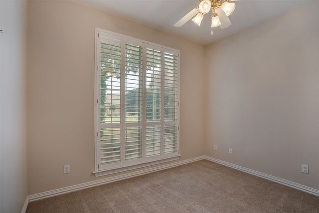 Carpeted empty room featuring ceiling fan and baseboards | Image 23