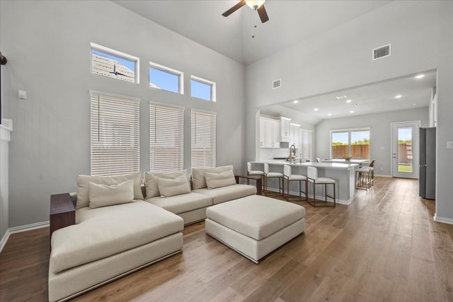 Living Room with high ceilings, fan, electric fireplace | Image 6