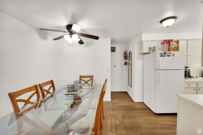 Dining space featuring light wood-style floors and a ceiling fan | Image 8