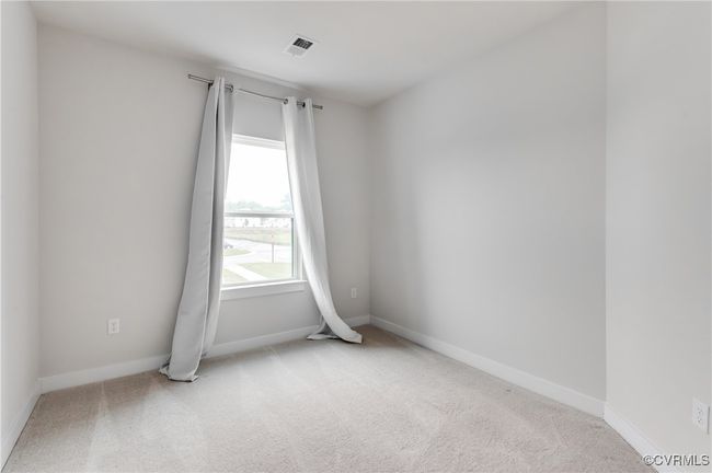 Unfurnished room featuring light colored carpet and baseboards | Image 23