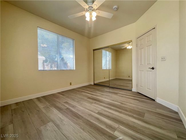 Unfurnished bedroom featuring a closet, ceiling fan, wood finished floors, and baseboards | Image 4