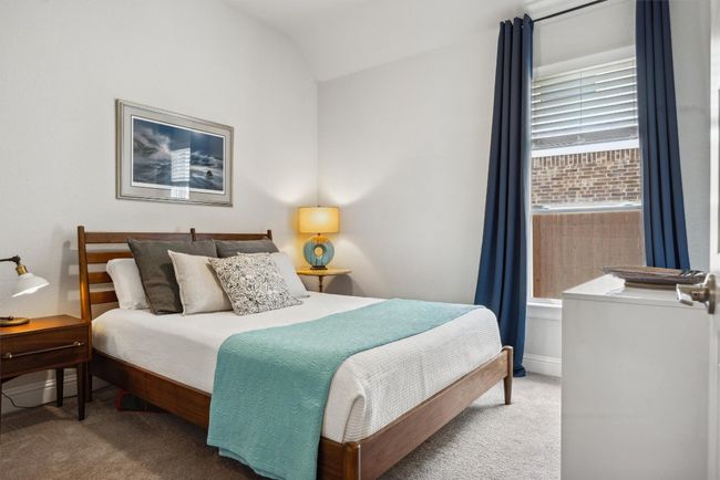 Bedroom featuring carpet flooring and lofted ceiling | Image 16