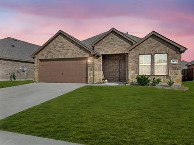 View of front of home with a garage and a lawn | Image 1