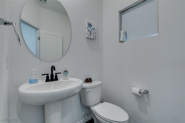 Half bath with visible vents, toilet, and a sink | Image 22