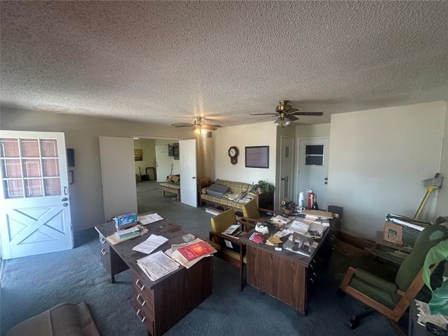 Home office with a ceiling fan, carpet, and a textured ceiling | Image 17