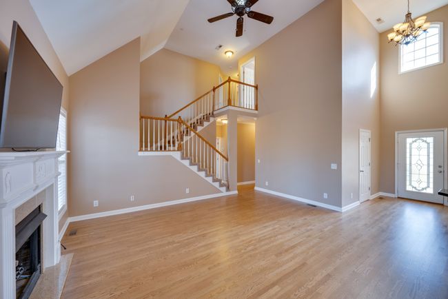 Grand view of the staircase and open floor plan. | Image 7
