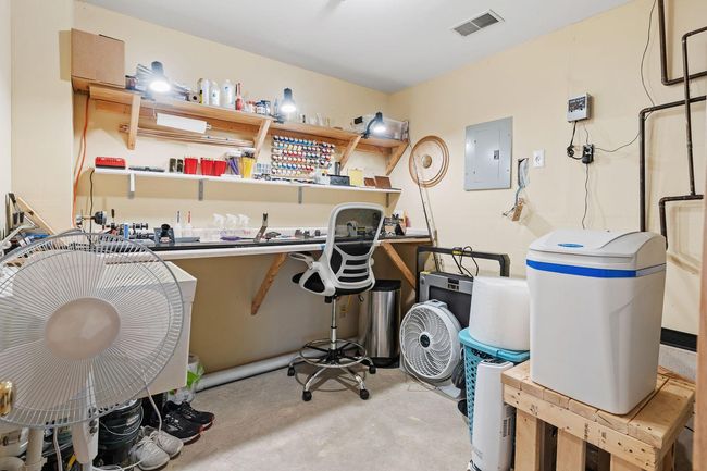 This mechanical room is as clean as they come with built-in workbench. | Image 51