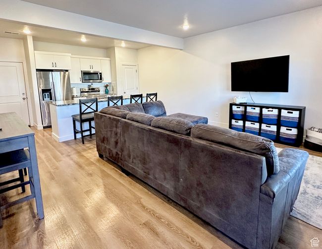Living area with baseboards and light wood-style floors | Image 4