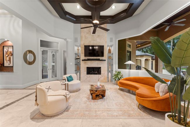 The den strikes a perfect balance between comfort and sophistication, featuring a beautifully designed focal fireplace that anchors the room with understated elegance | Image 14